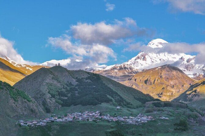From Tbilisi: Kazbegi Day Tour, Gergeti Trinity, Ananuri &Gudauri - The Russian-Georgian Friendship Monument: A Soviet-Era Signpost in the Mountains